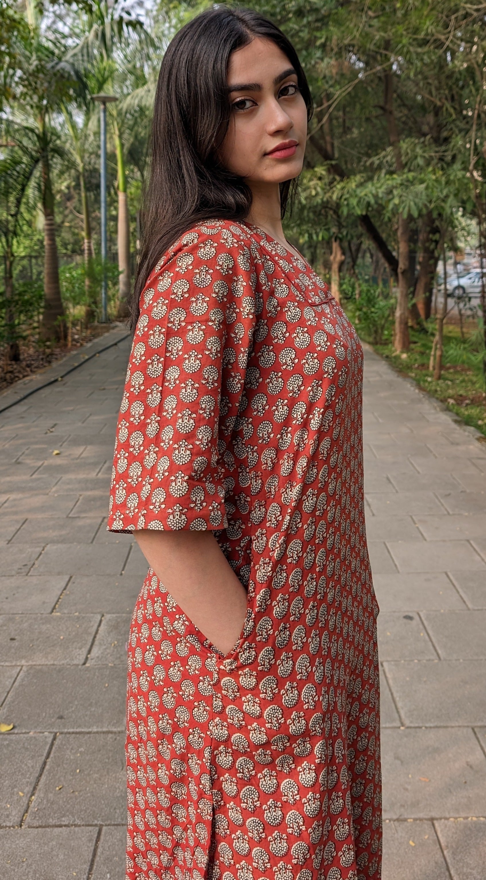 Girl standing on road wearing lotus print Kurti by neelmii