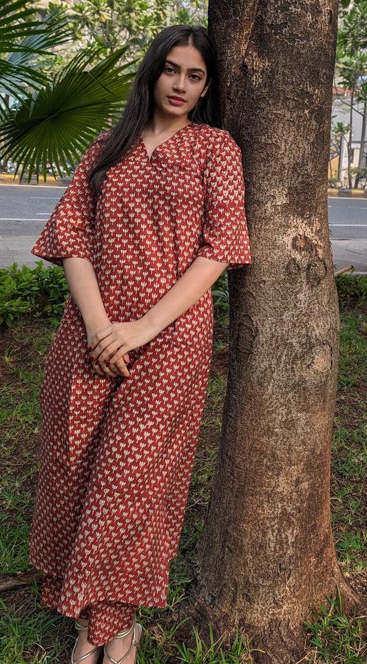 Girl standing behind tree wearing lotus print Kurti by neelmii