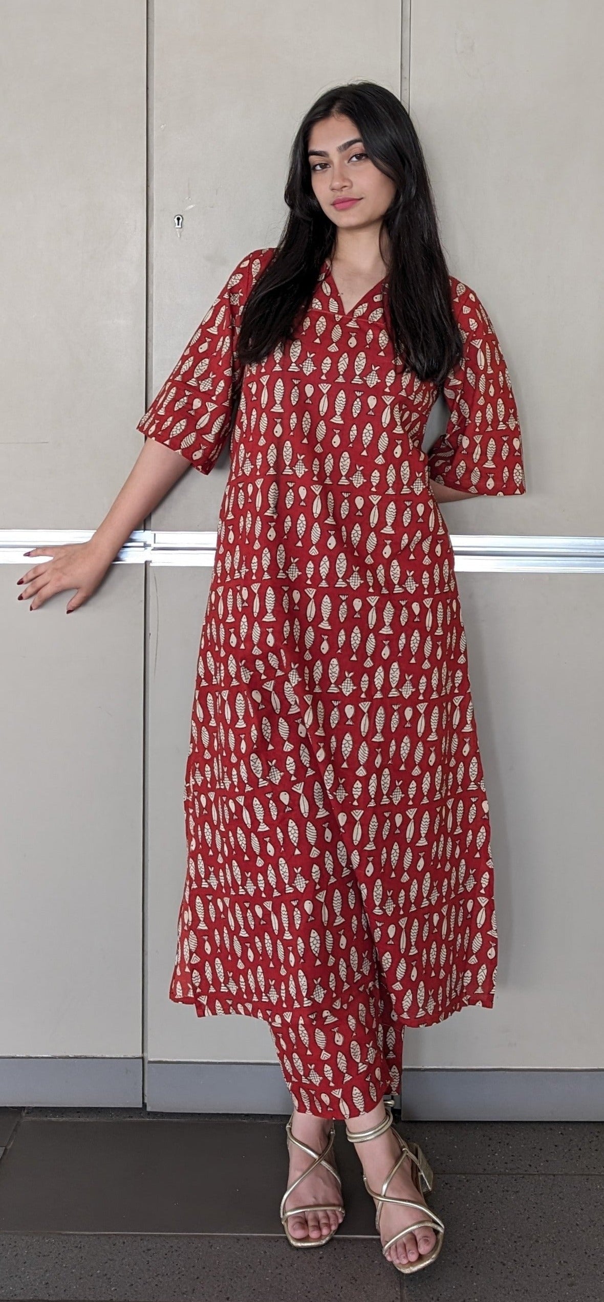 A girl standing wearing Kurtha set by Neelmii fish print